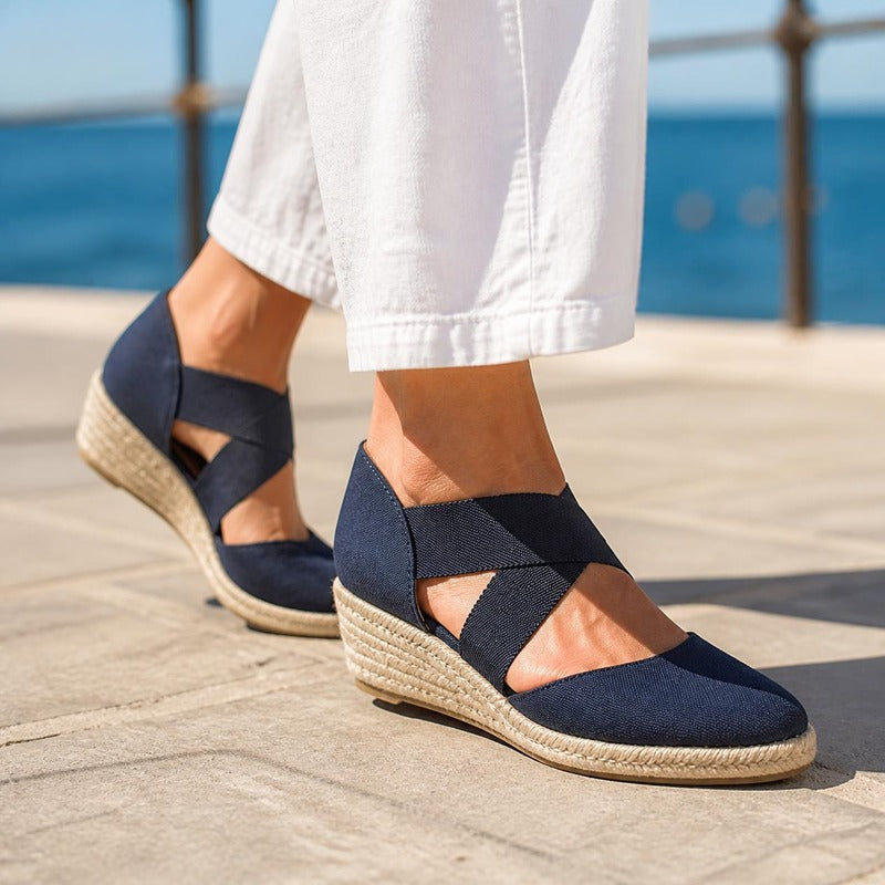 The Capri Espadrille Wedge in Navy, worn by the sea