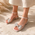 Crystal Bow Sandal in champagne, worn