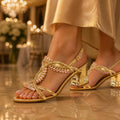 The Gilded Jewel Heel in Gold, worn at an evening wedding