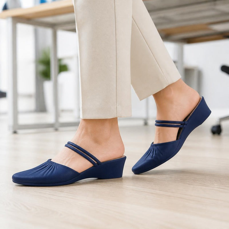 The Pointed Wedge Mule in Navy, worn at the office